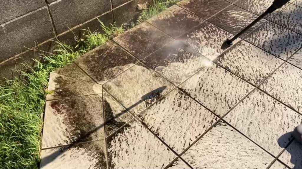 高圧洗浄機でタイルを洗浄している写真